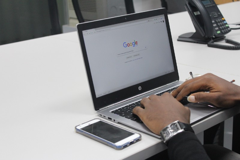 image of a user using a laptop for Google search