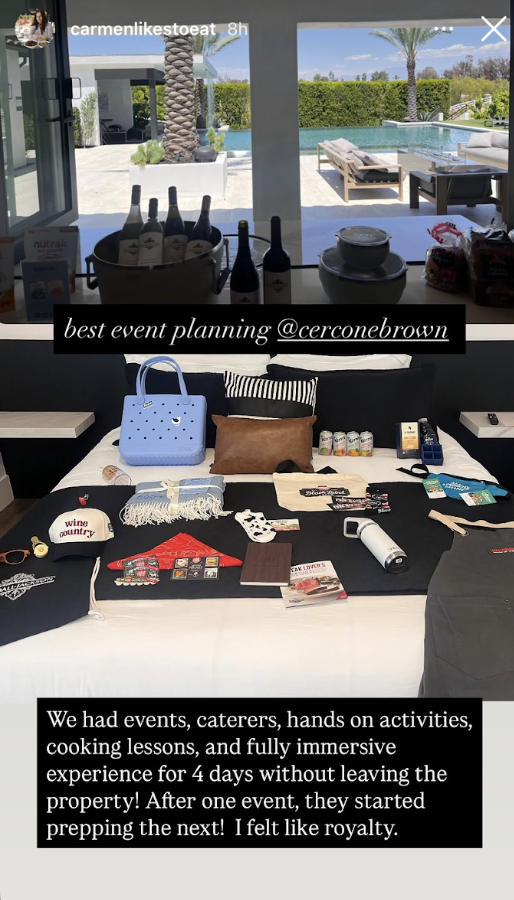 An Instagram Story from @carmenlikestoeat showing a welcome gift spread on a bed — branded swag, snacks, a Crocs bag, blanket, and wine country hat — alongside a caption praising @cerconebrown for "best event planning" and calling the 4-day immersive experience "royalty" treatment.