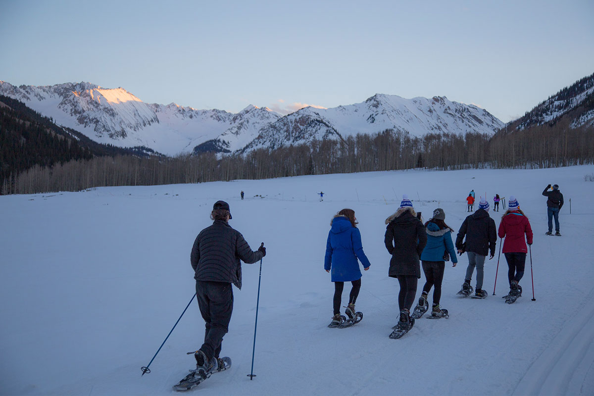 people snowshoeing with mountains in background at CBC Aspen