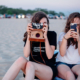 Two female Gen Z teenagers take photos