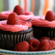 Red frosted chocolate cupcakes with raspberries