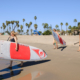 Group of women on beach with paddleboards