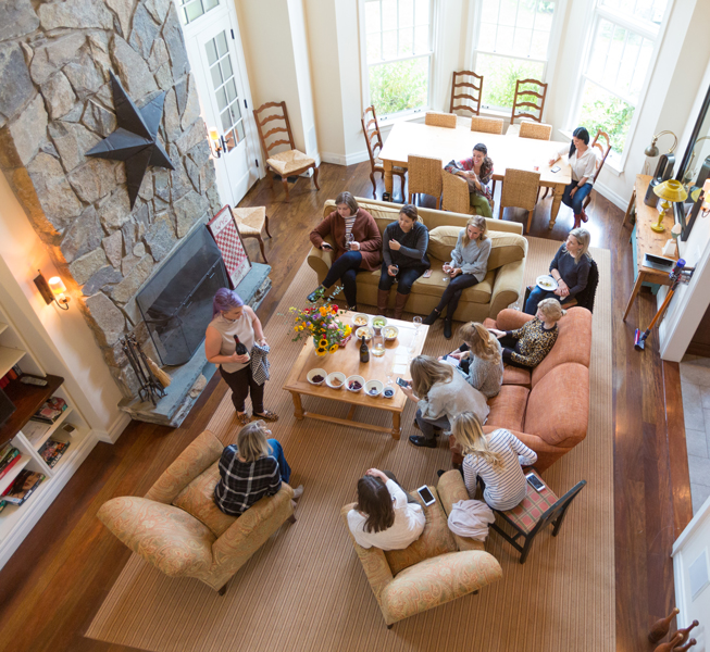 influencers and press sitting around living room at CBC Hosting House