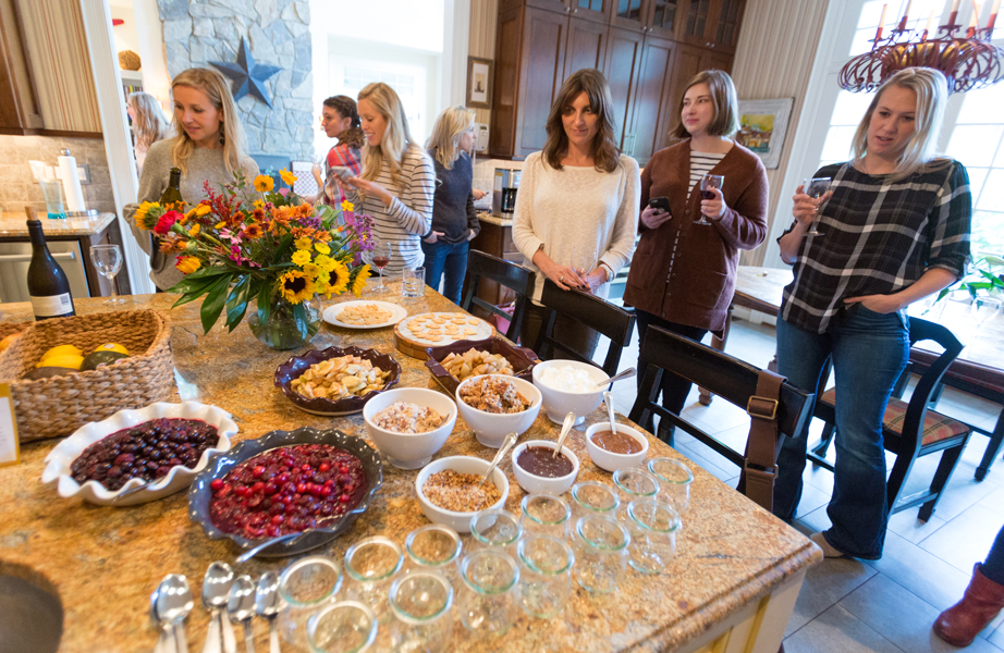 Influencers and press standing around kitchen counter at Hosting House