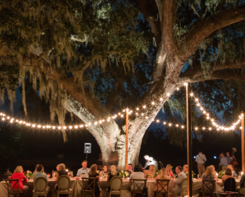 Influencers and press eating dinner outdoors at Charleston experience