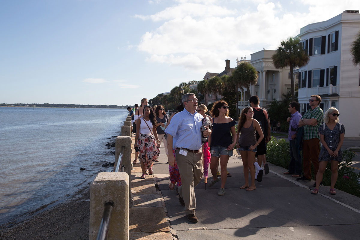people walking besides the sea at CBC Charleston experience