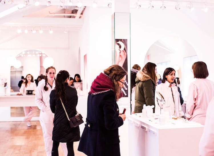 Makeup shoppers at a Glossier pop-up store