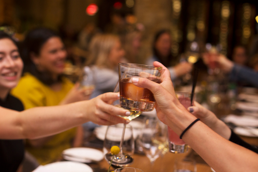 Influencers and press toasting cocktails at dinner at Culinary House