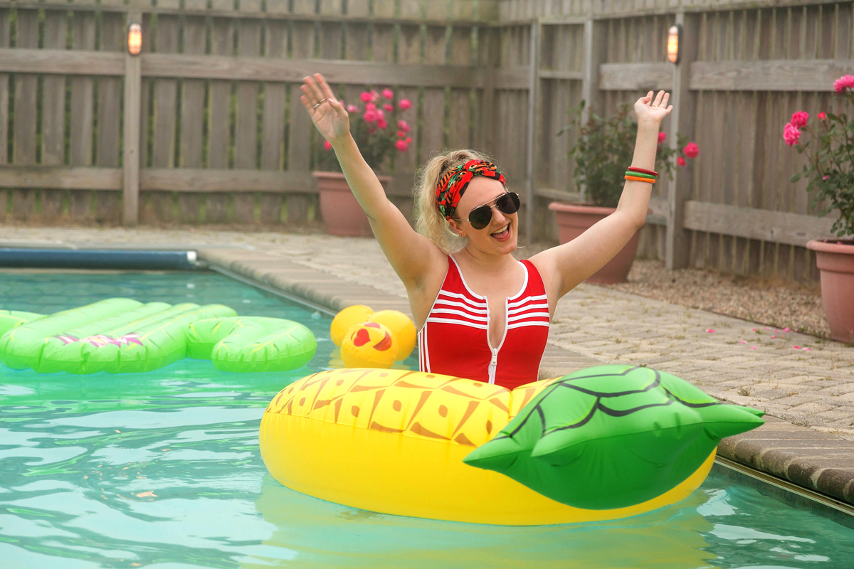 Miraclesuit woman in water with pineapple floatie