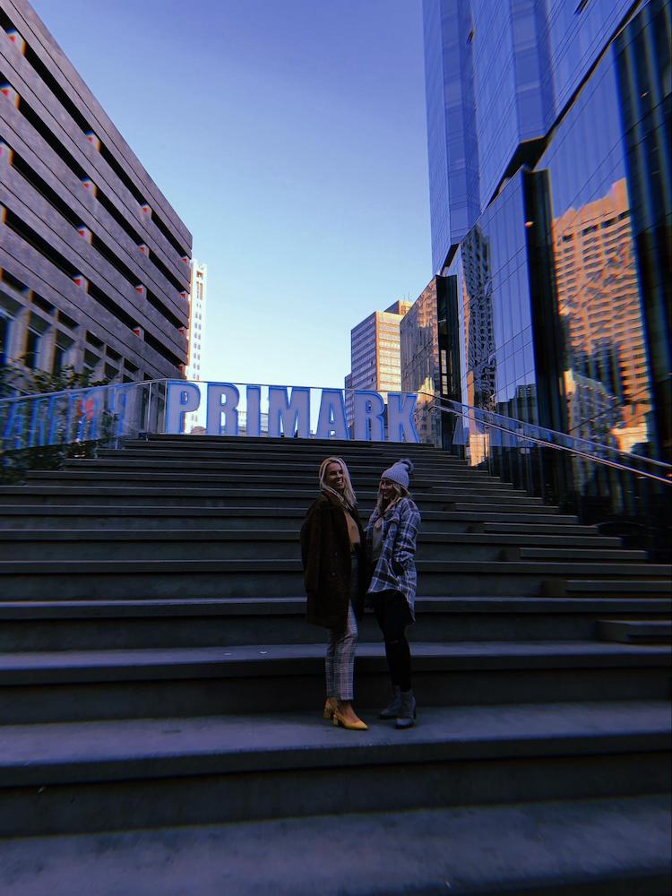 Cercone Brown interns stand in front of Primark sign in Downtown Crossing after fashion show