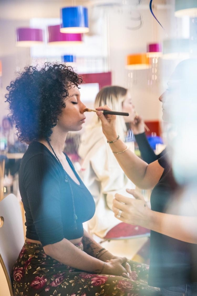 Behind the scenes of model getting her makeup done