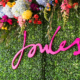 Joules Right As Rain event name on floral wall