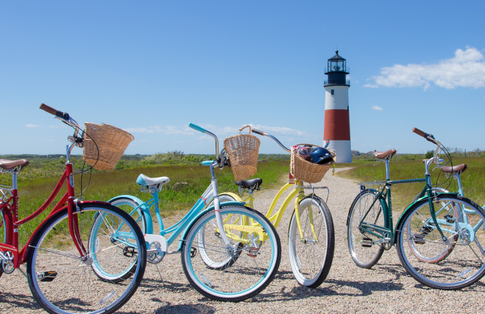 Four colorful bikes outside of a lighthouse at Parenting Experience