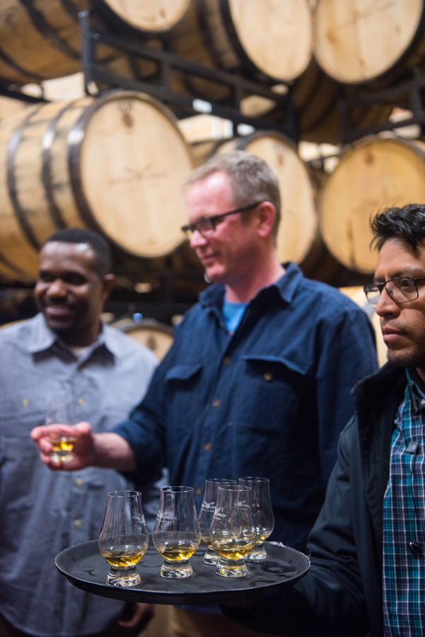 Press tasting whisky at a distillery at Aspen Experience
