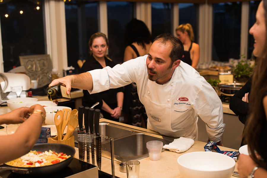 Barilla chef pouring olive oil into pasta dish at Culinary House