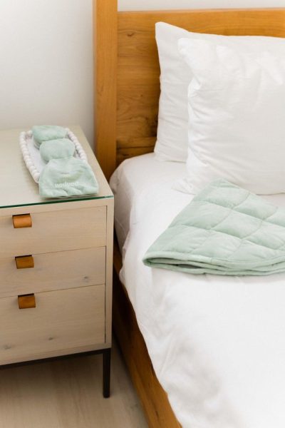 Nodpod weighted blanket and sleep mask in a bedroom at CBC Health House